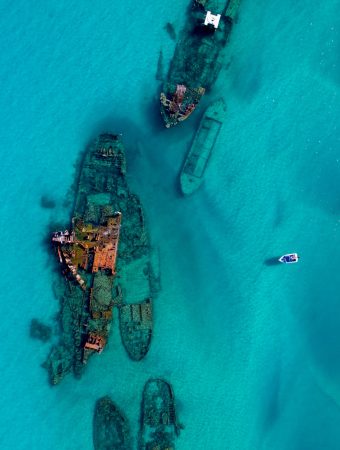 Aerial view of the Tangalooma Wrecks - Located alongside Tangalooma Island Resort are the picturesque Tangalooma Wrecks, a cluster of scuttled ships, providing incredible snorkelling & kayaking.